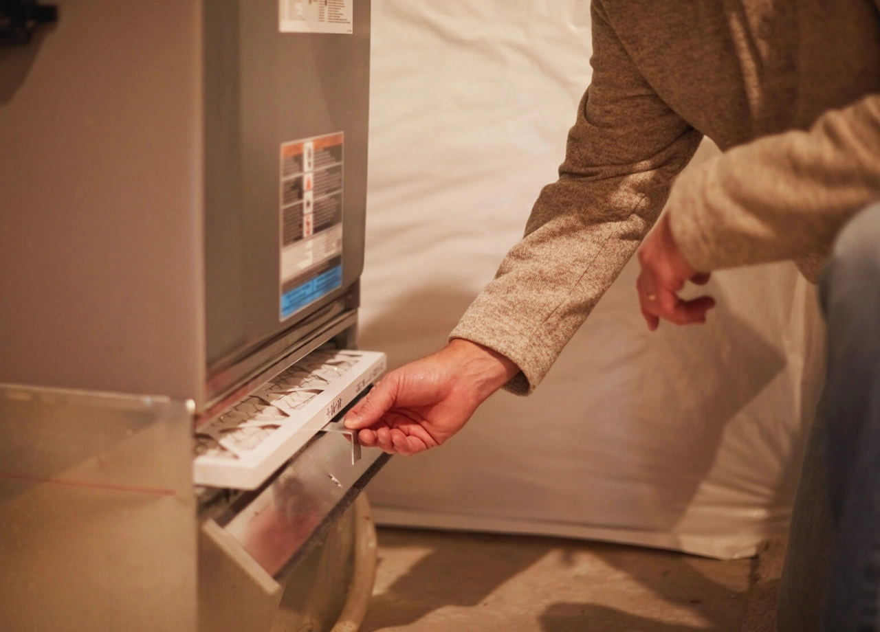 Homeowner checking a pleated air filter in their Central Oregon home Homeowner checking a pleated air filter in their Central Oregon home