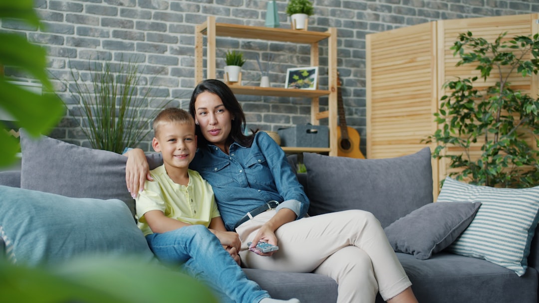 comfortable family in a living room with a heat pump unit visible - home heat pump maintenance in redmond, or