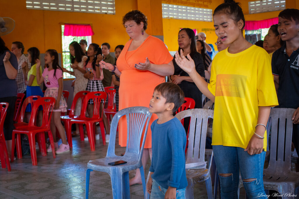 Annie worshipping with her home church in Cambodia