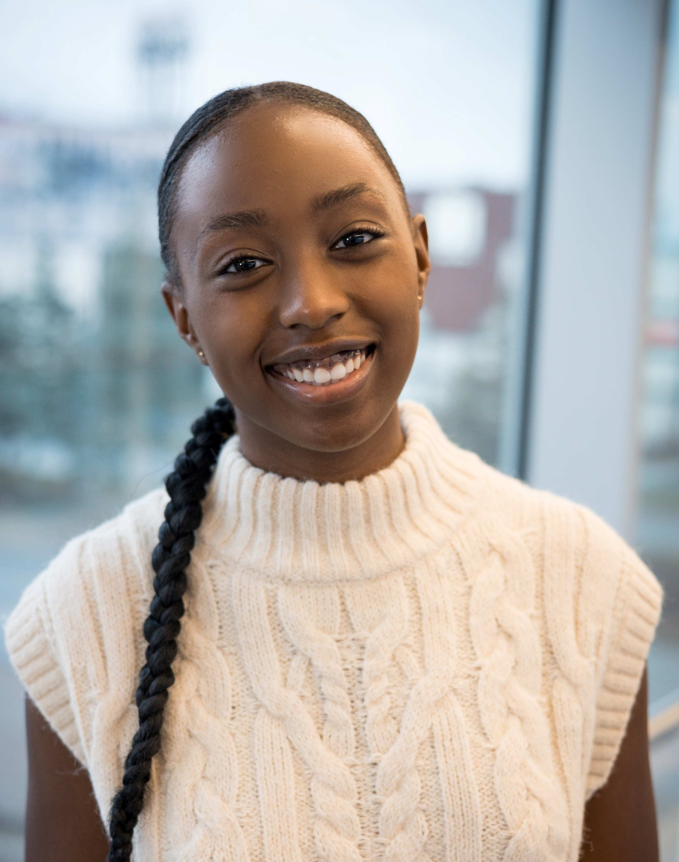 Summer Nitsch - smiling woman with long blonde hair wearing a royal blue dress and a gold necklace.
