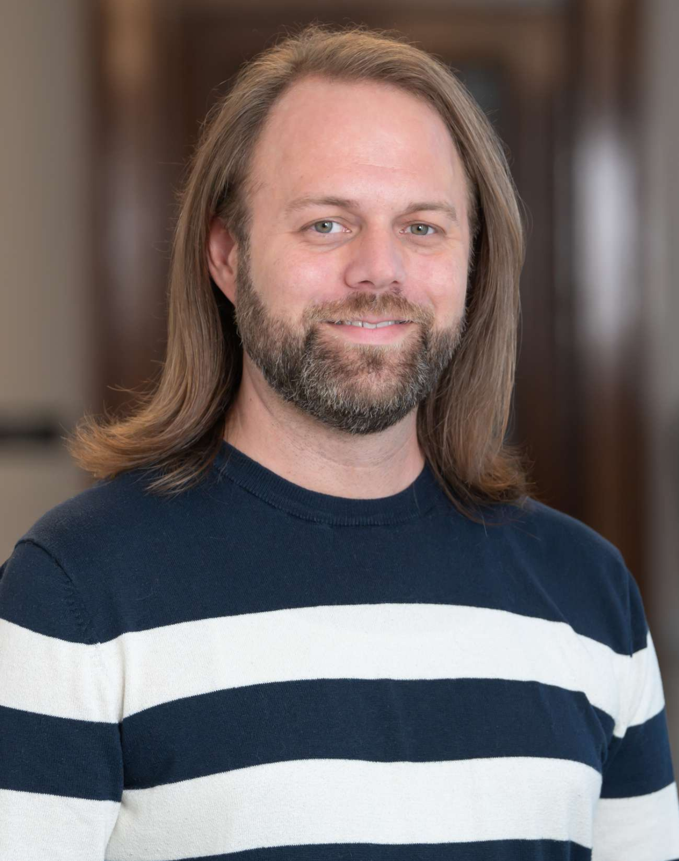 Summer Nitsch - smiling woman with long blonde hair wearing a royal blue dress and a gold necklace.