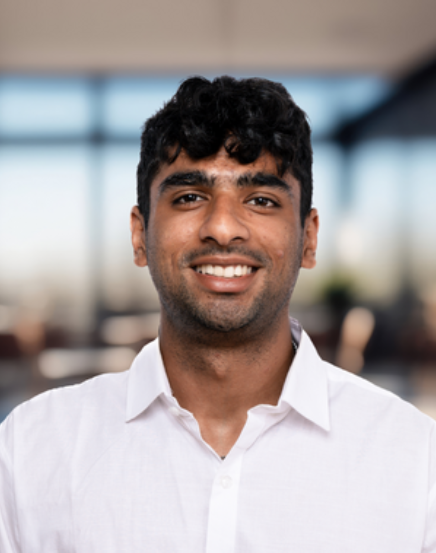 Summer Nitsch - smiling woman with long blonde hair wearing a royal blue dress and a gold necklace.