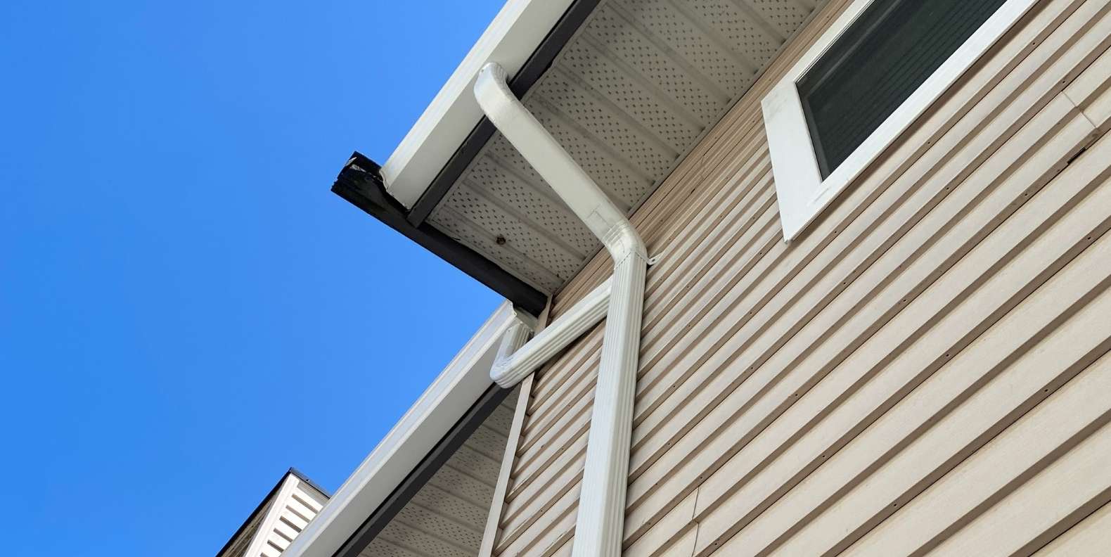 Completed gutter replacement project with clean aluminum finish and precise slope alignment in Richmond, BC