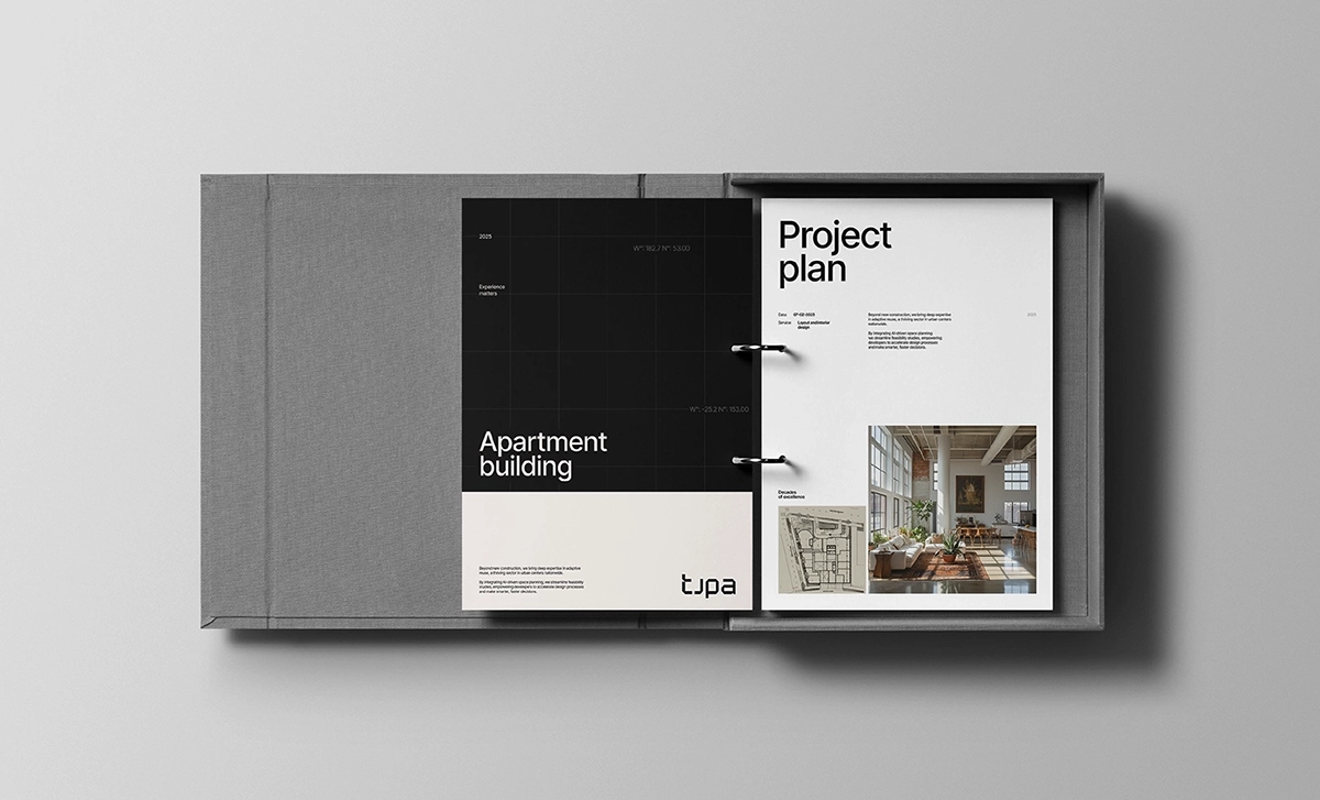 Open binder with minimalist project plan and architectural layout.