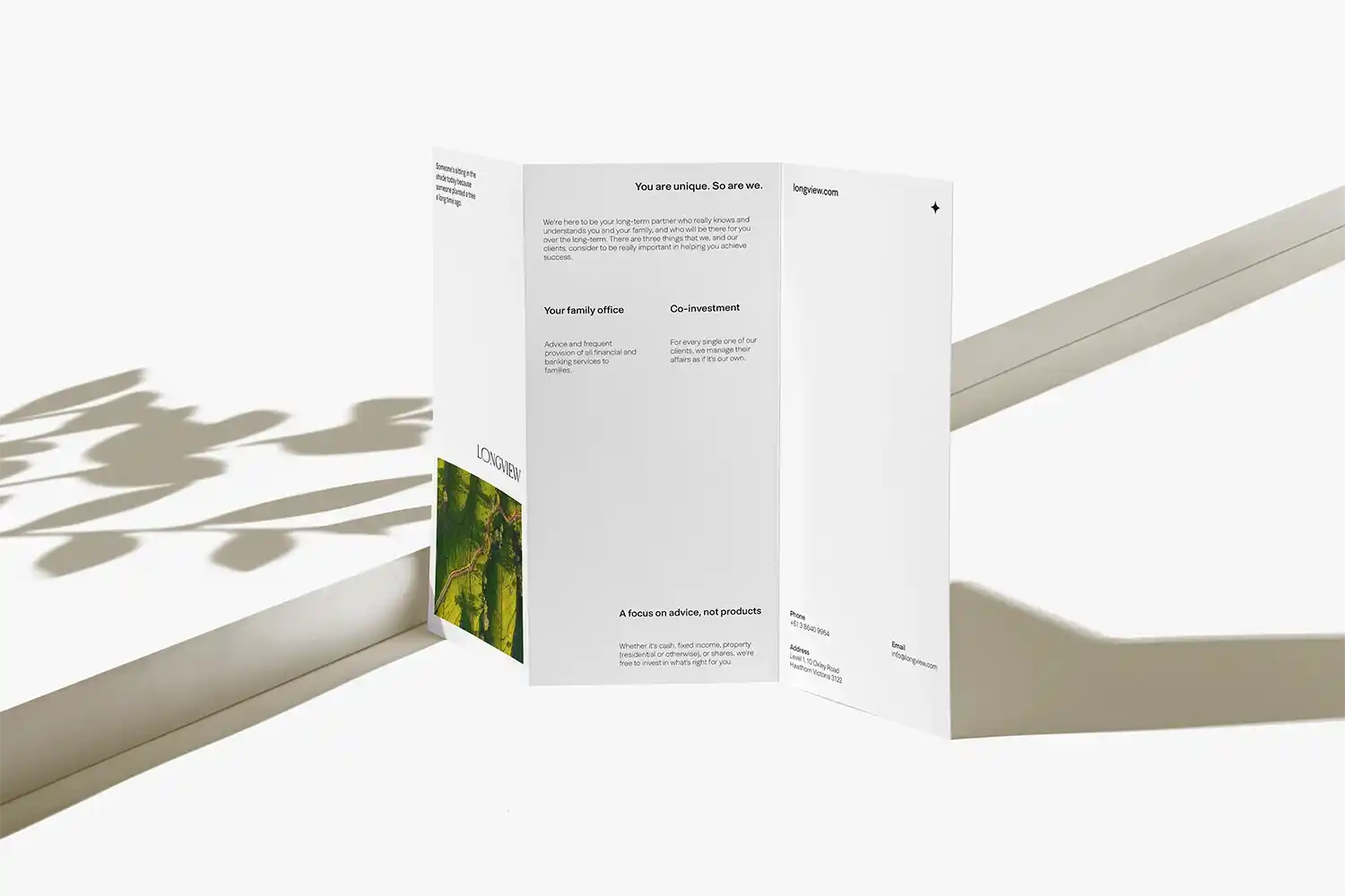 Minimal tri-fold brochure with clean white layout and soft shadows.