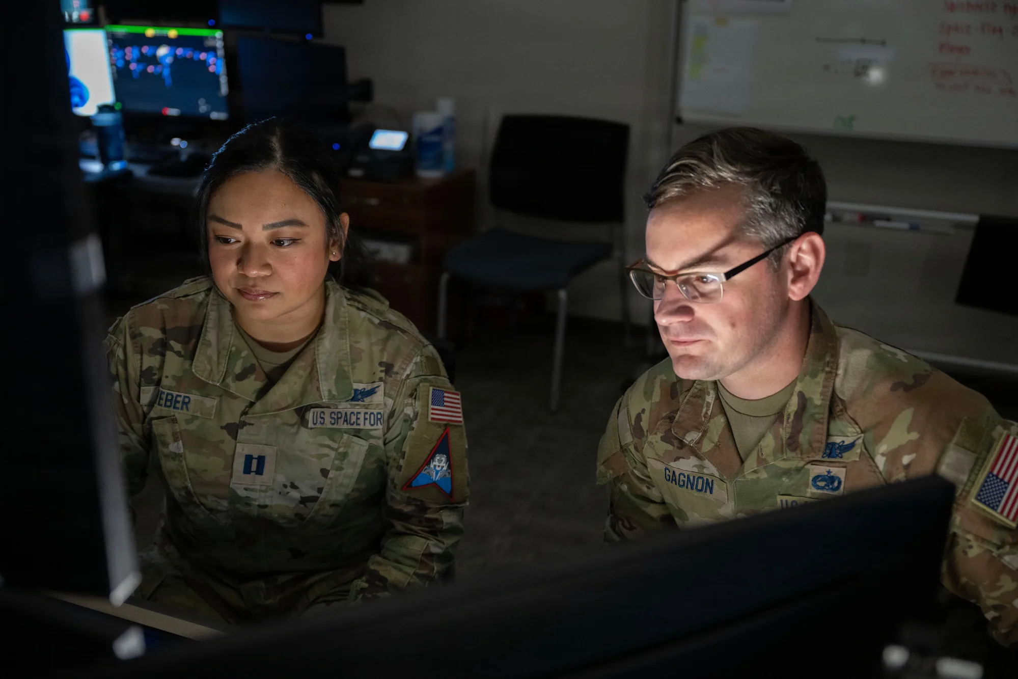 Operators at consoles in an operations center