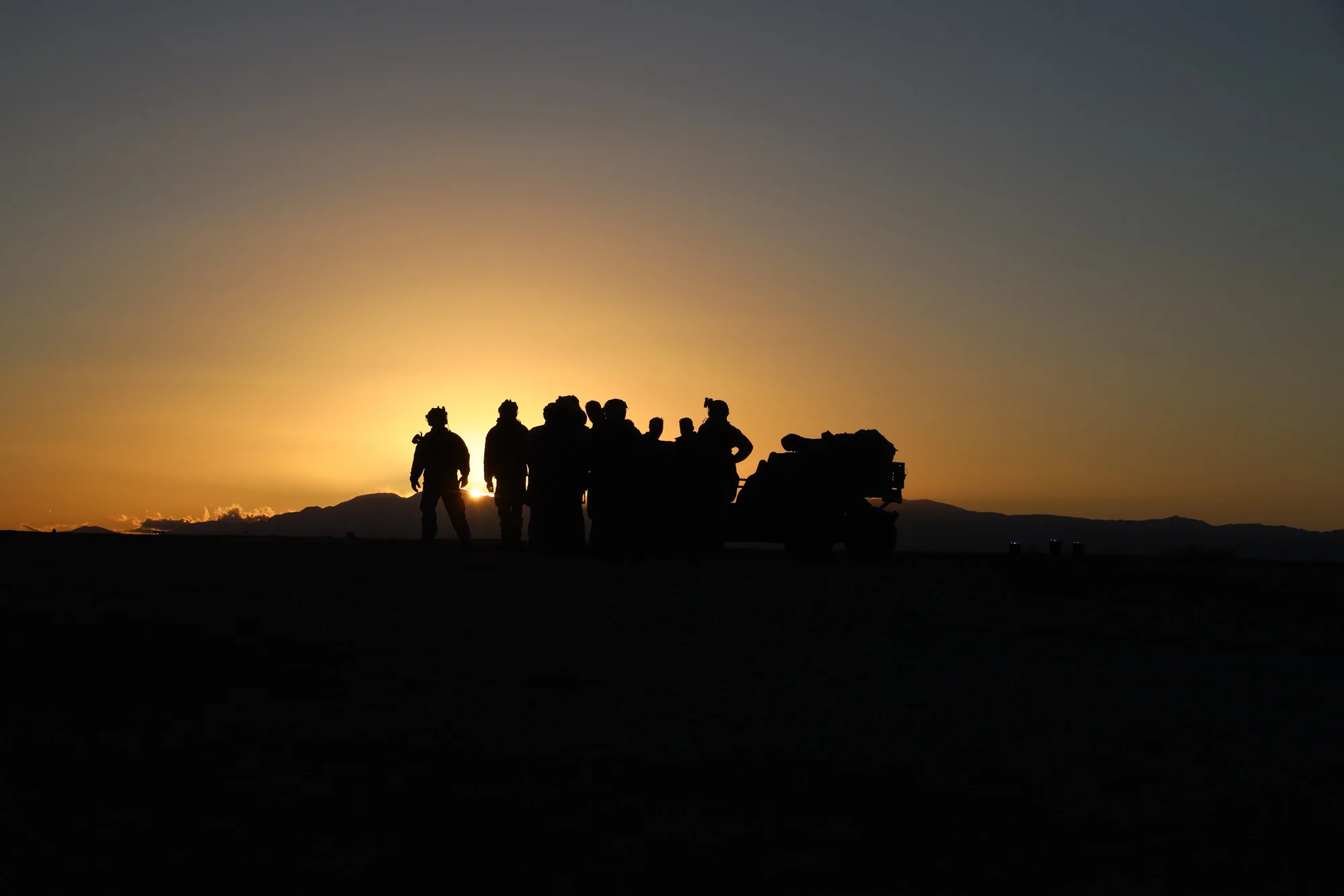Marines silhouetted on the horizon at last light