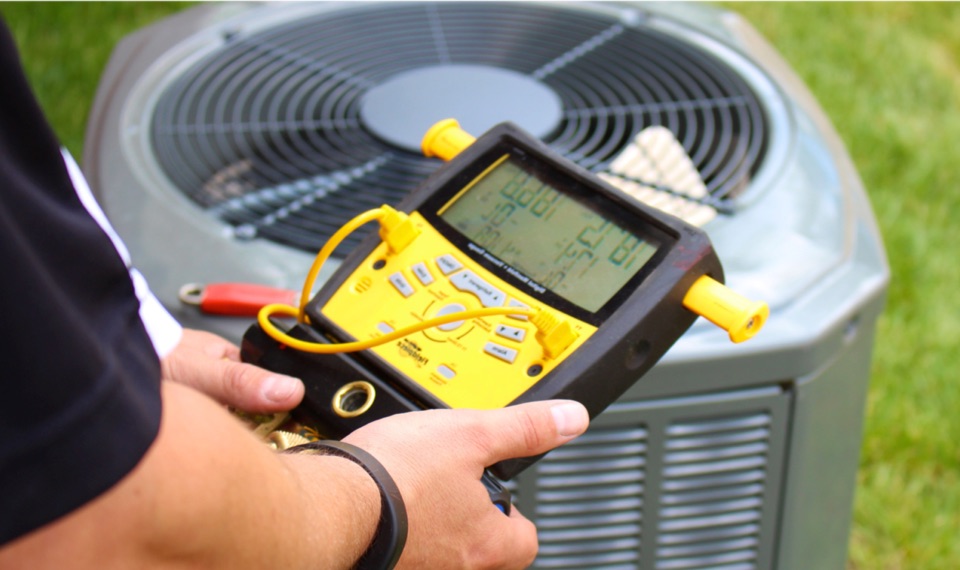 HVAC Technician working on a unit on rooftop