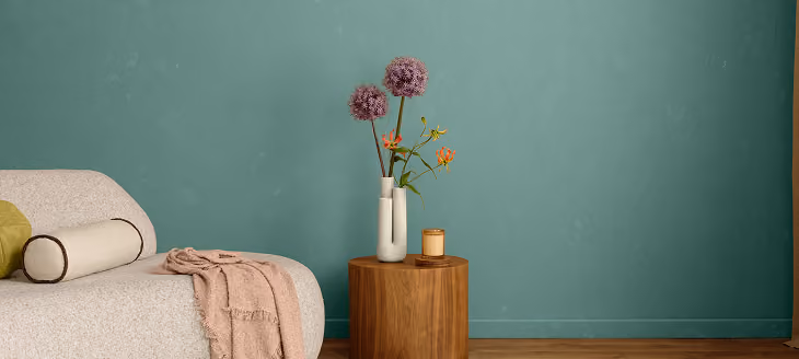 Minimalist bedroom with a muted teal accent wall
