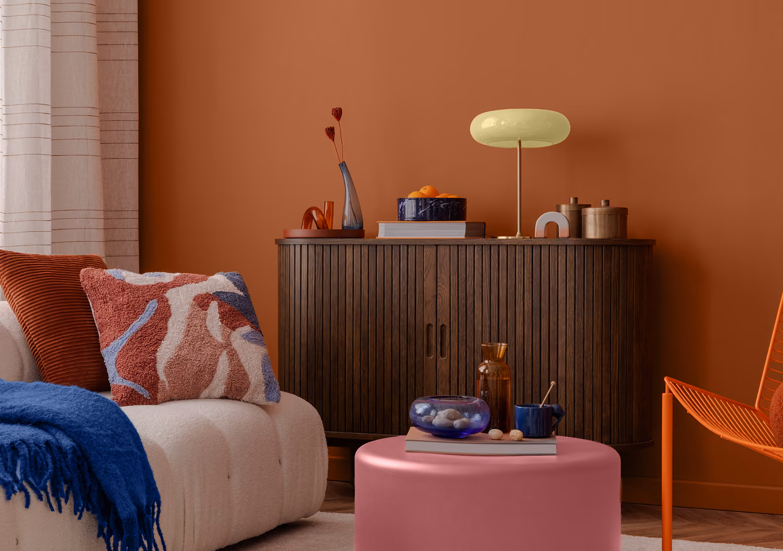 Modern living room with terracotta wall and white sofa