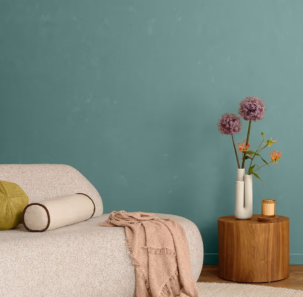 Minimalist bedroom with a muted teal accent wall