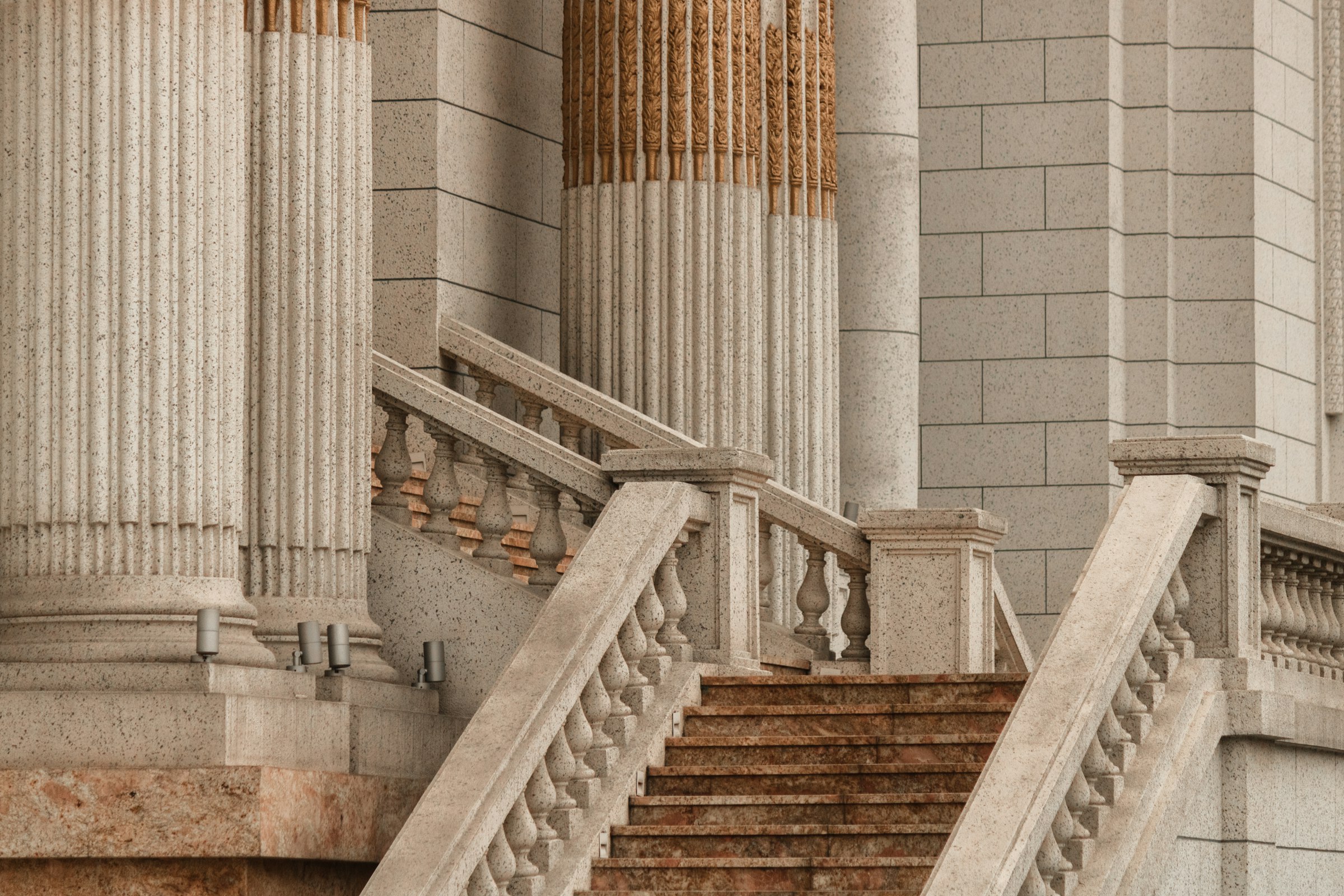Stone courthouse staircase lined with classical columns