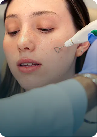 "Woman receiving a facial skin treatment with markings on her cheek