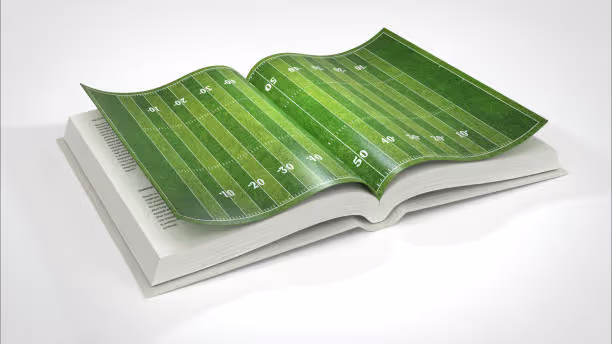 Open playbook showing a football field—metaphor for updating the shopper marketing 'playbook'