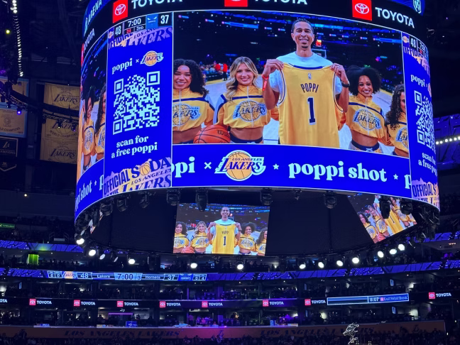 Crypto.com Arena jumbotron with QR code for free poppi can offer