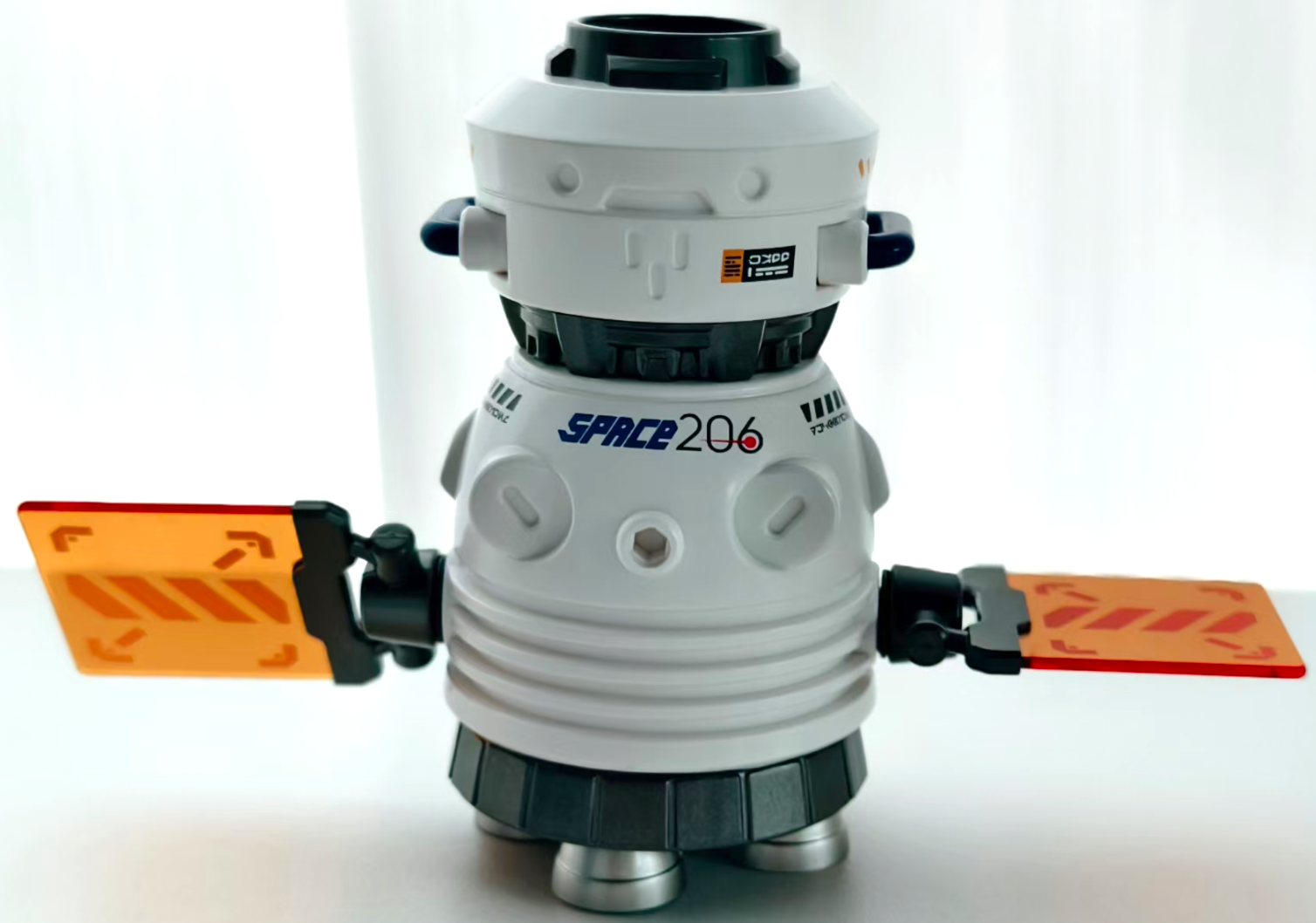 Chameleon Aerospace Dragon astronaut figure with orange capsule panels