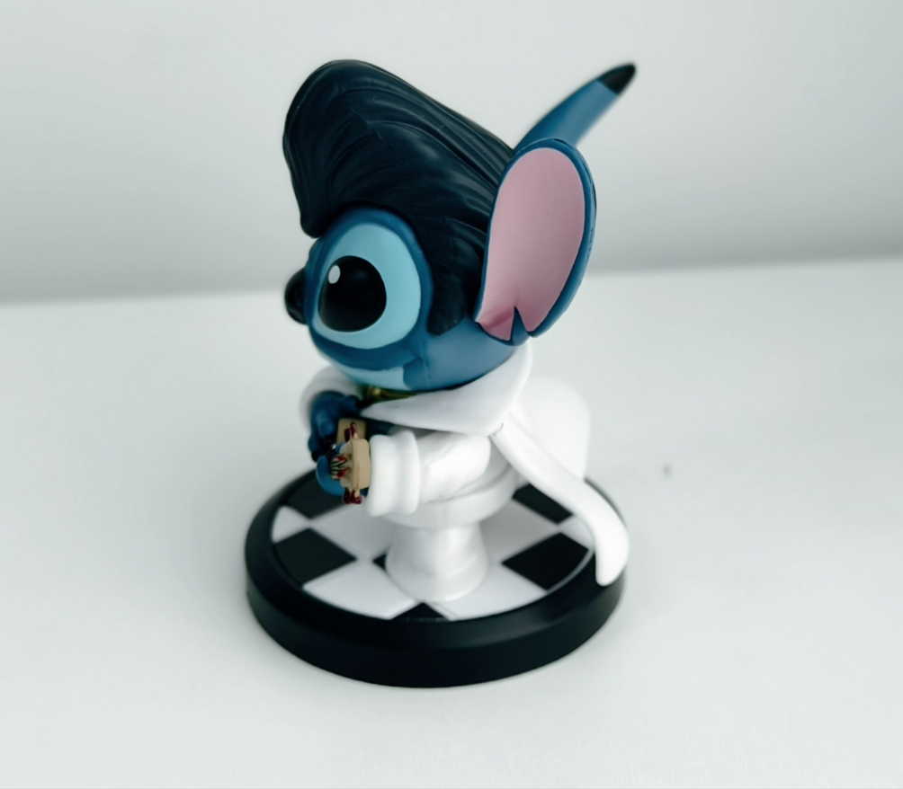 Blue alien character collectible with sculpted hair and astronaut costume