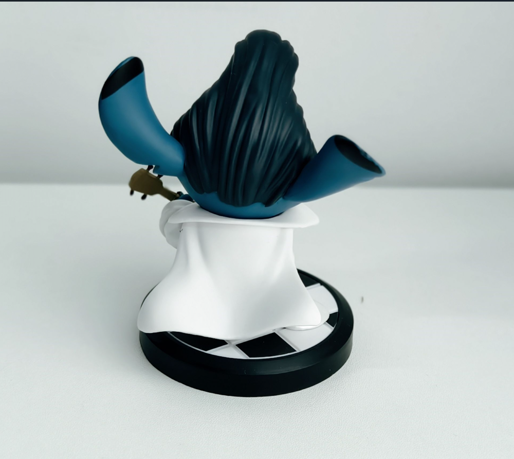 Blue character astronaut figurine in white space suit with musical instrument