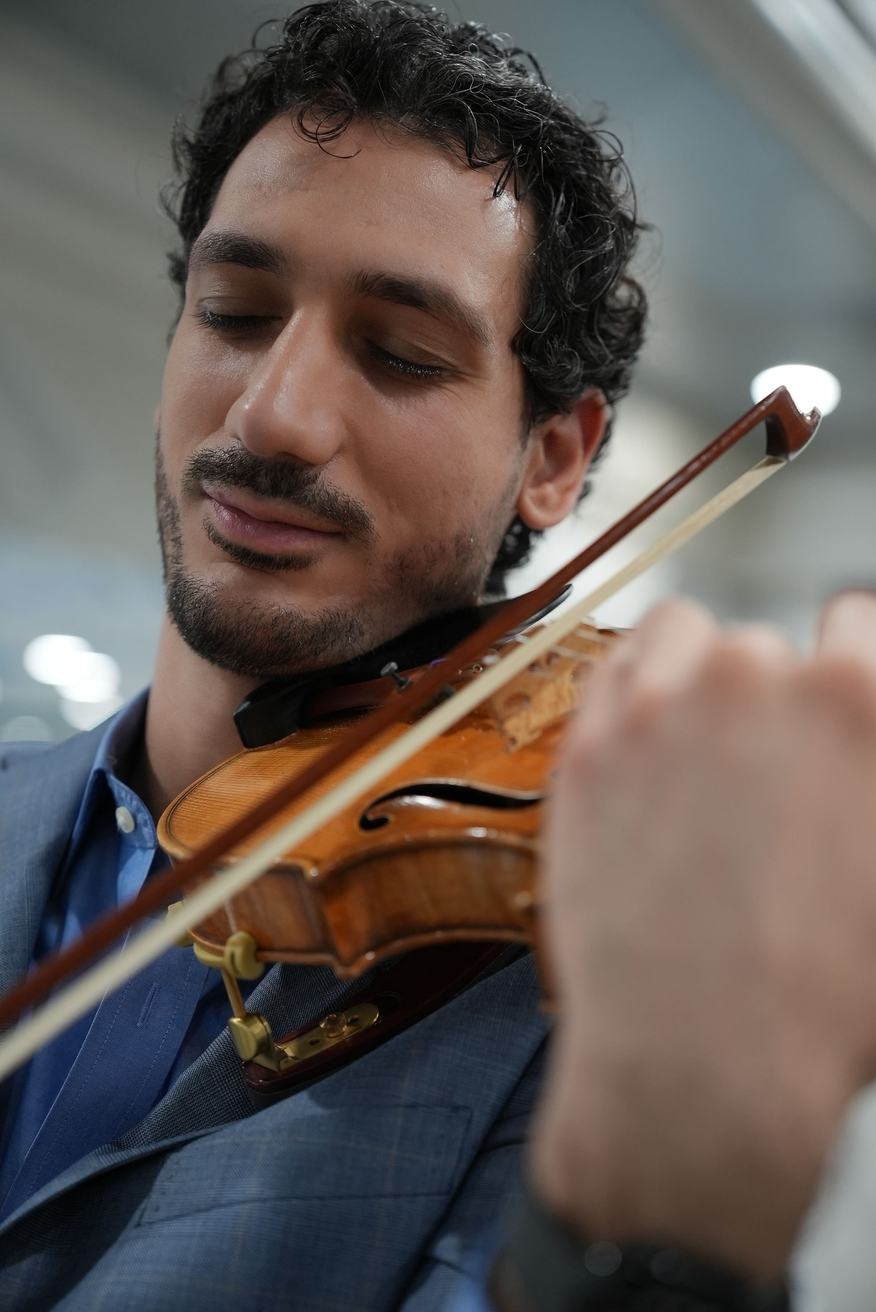 Nick Kelian preparing for a violin performance