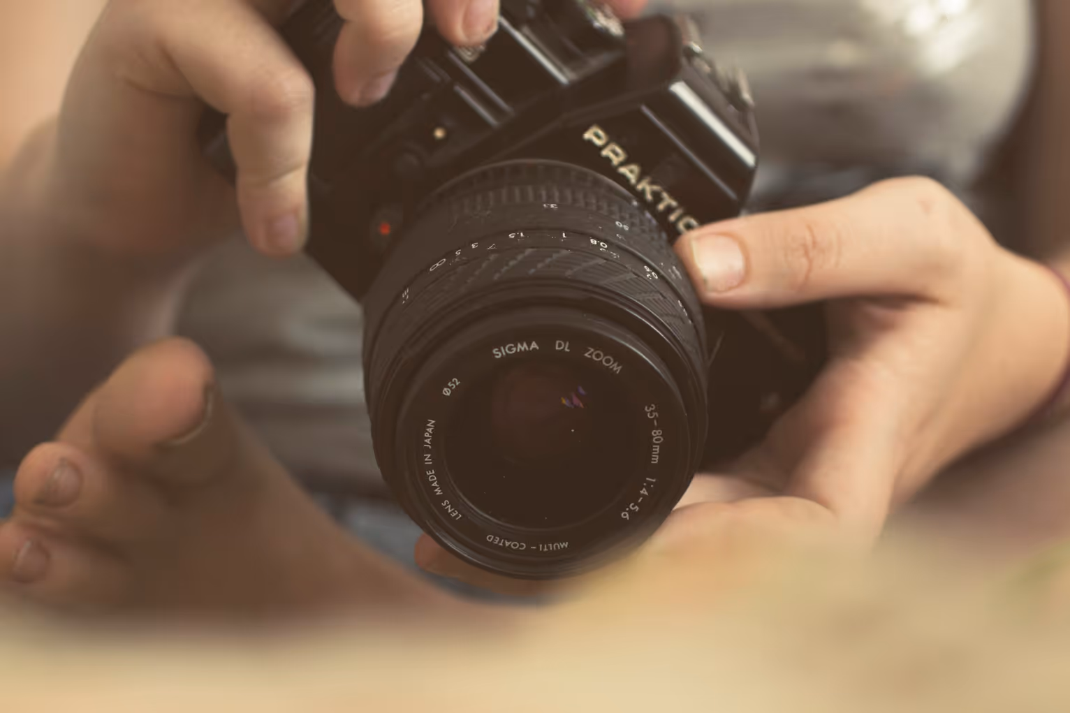 A camera being pointed towards feet with soft focus.
