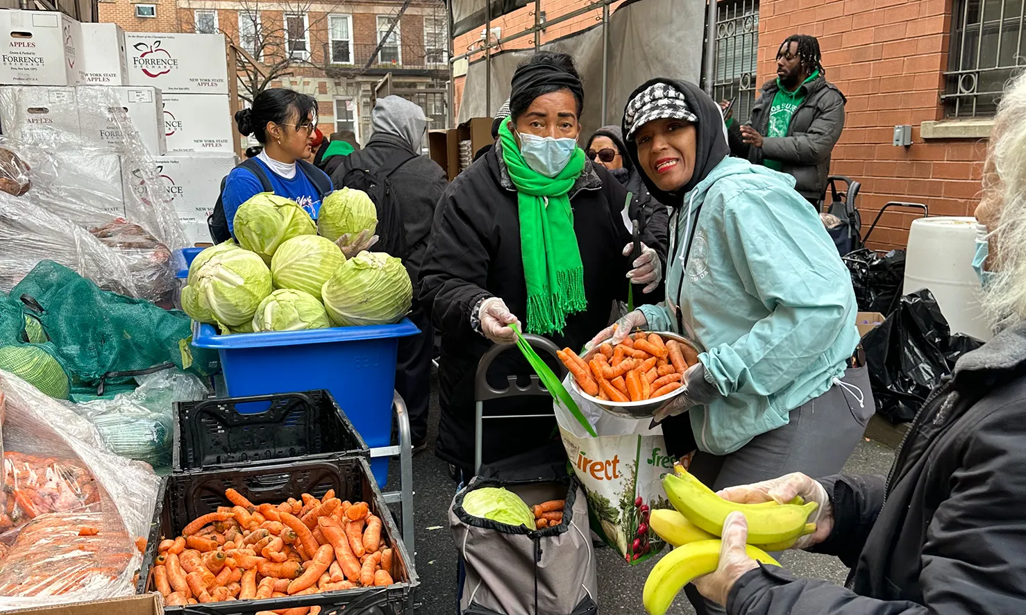 olunteers distributing fresh vegetables and groceries through social service programs in Lower East Side, NYC