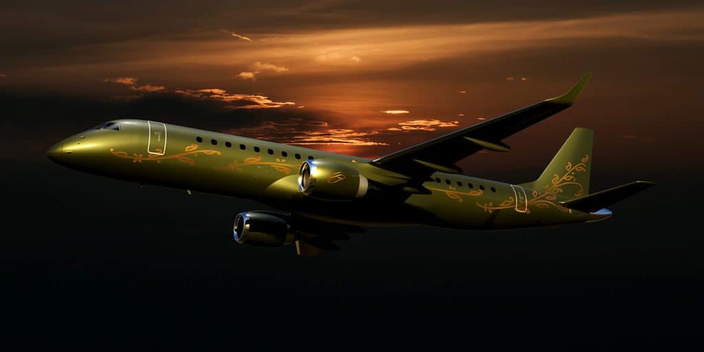 Green private jet with gold floral patterns flying against a dramatic sunset sky.