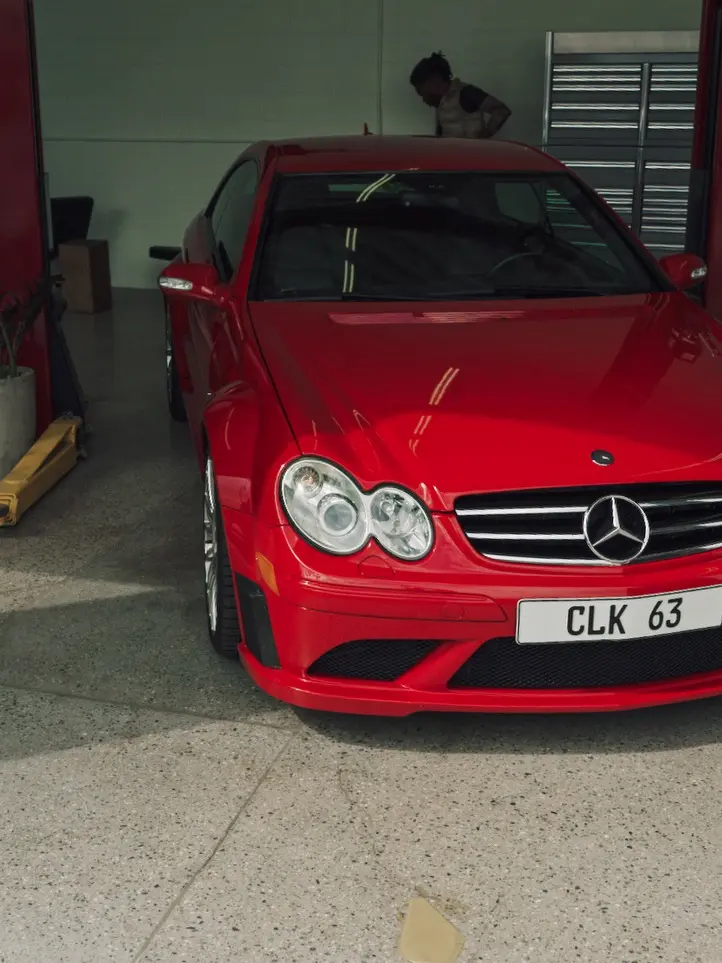 Red Mercedes CLK63 parked inside a garage