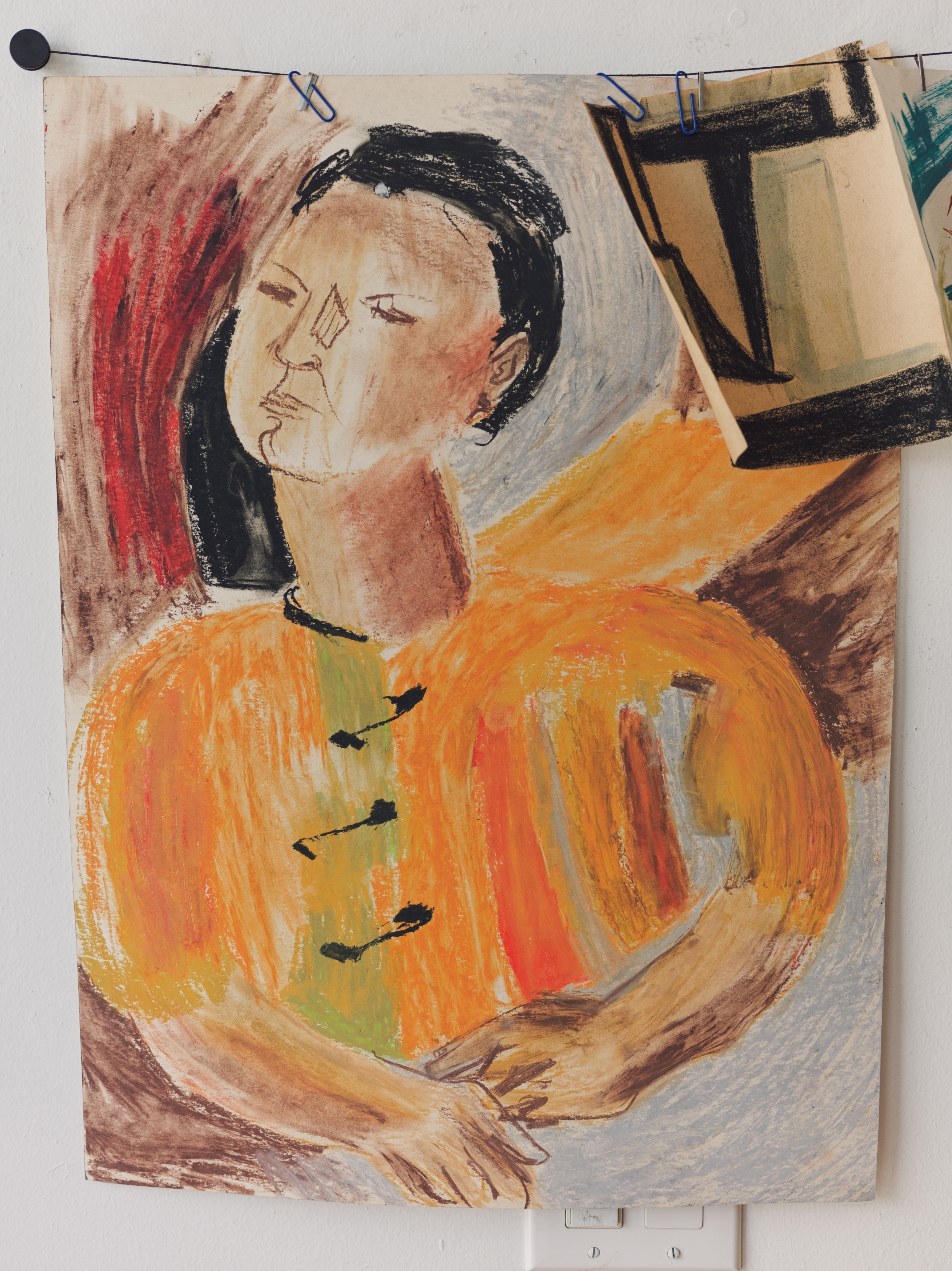 Pastel painting of a woman displayed on the wall at Jurassic Magic Mid-City