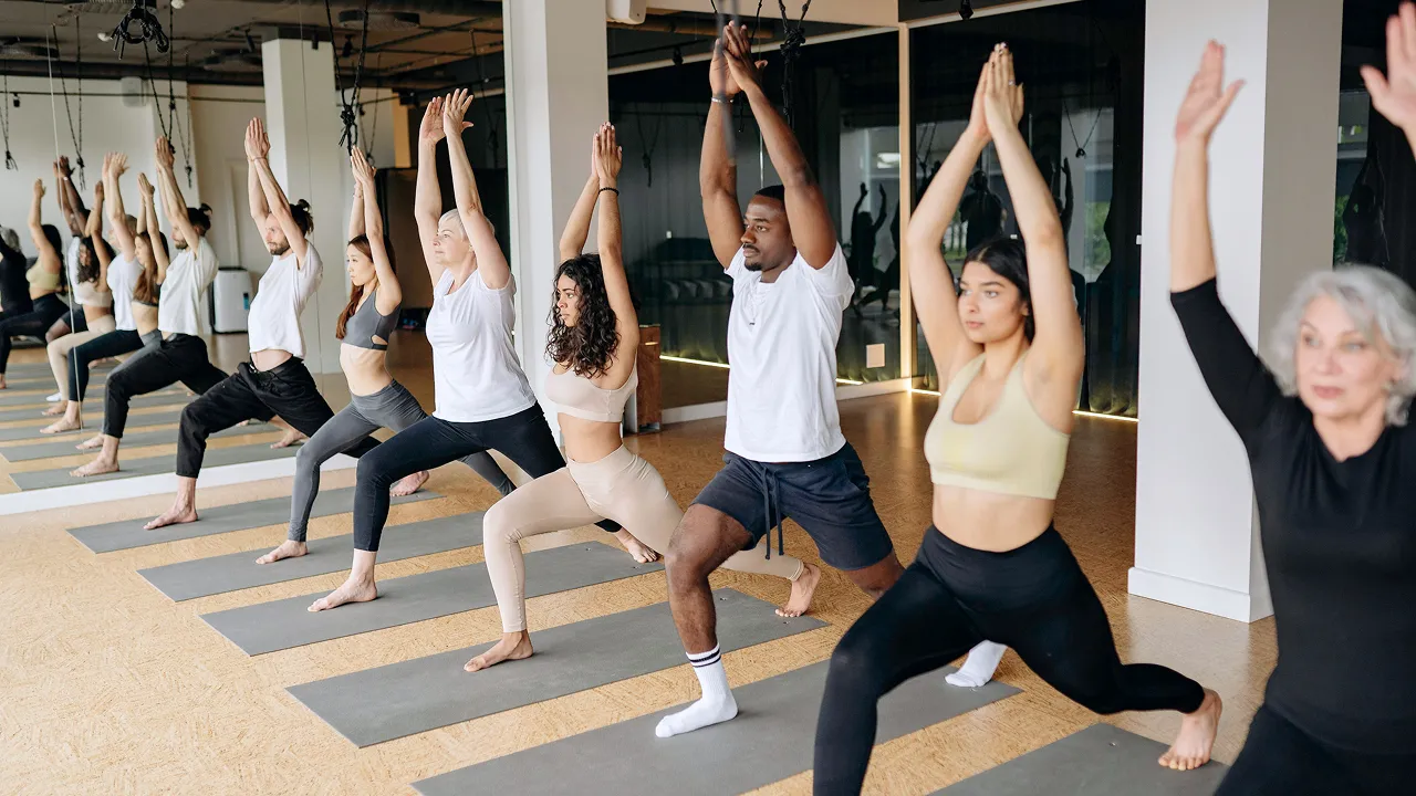 Group of people participating in a yoga class for community wellness.