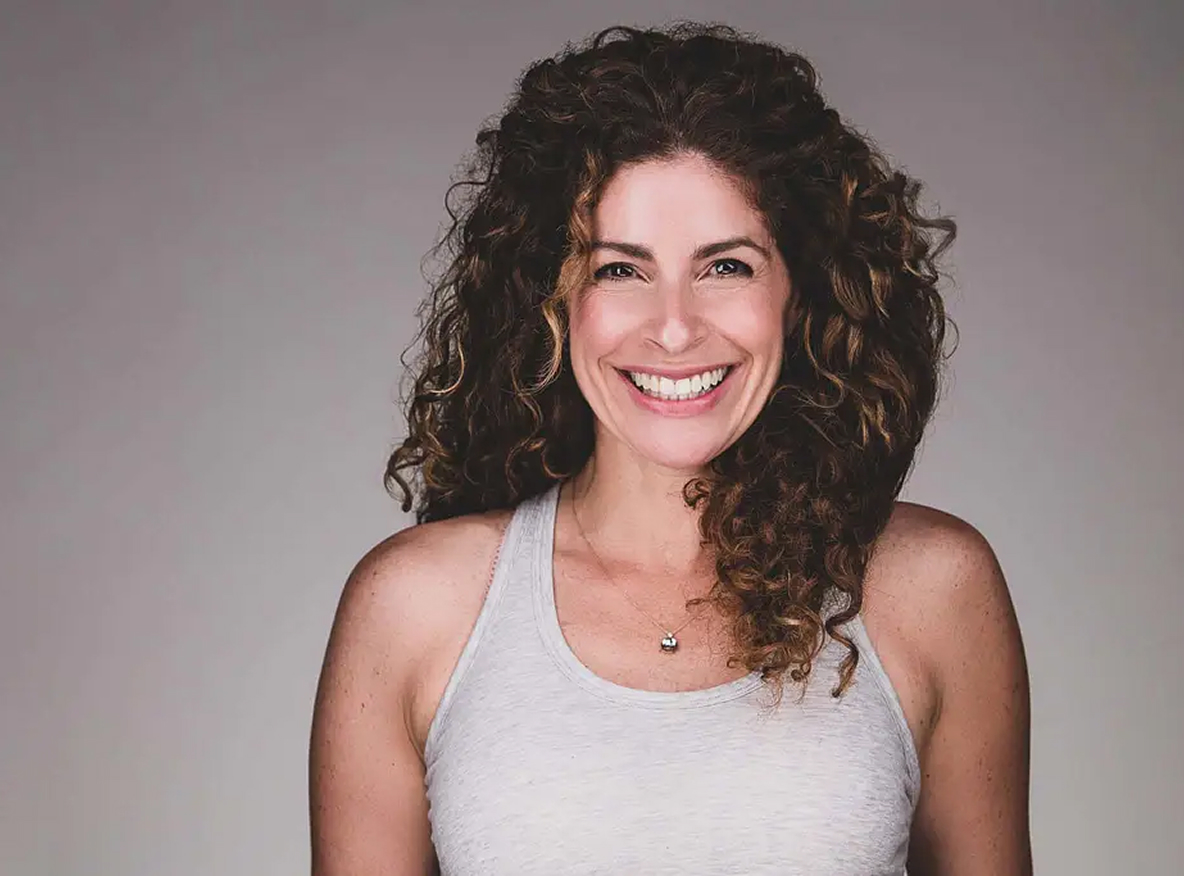 Wellness partner headshot of smiling fitness professional.