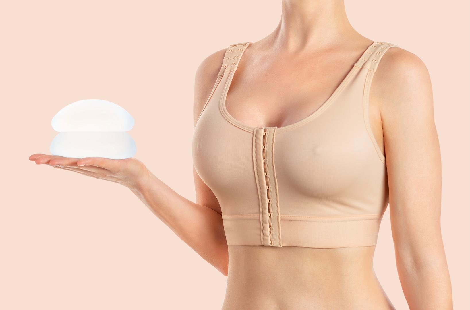 woman holding silicon implants