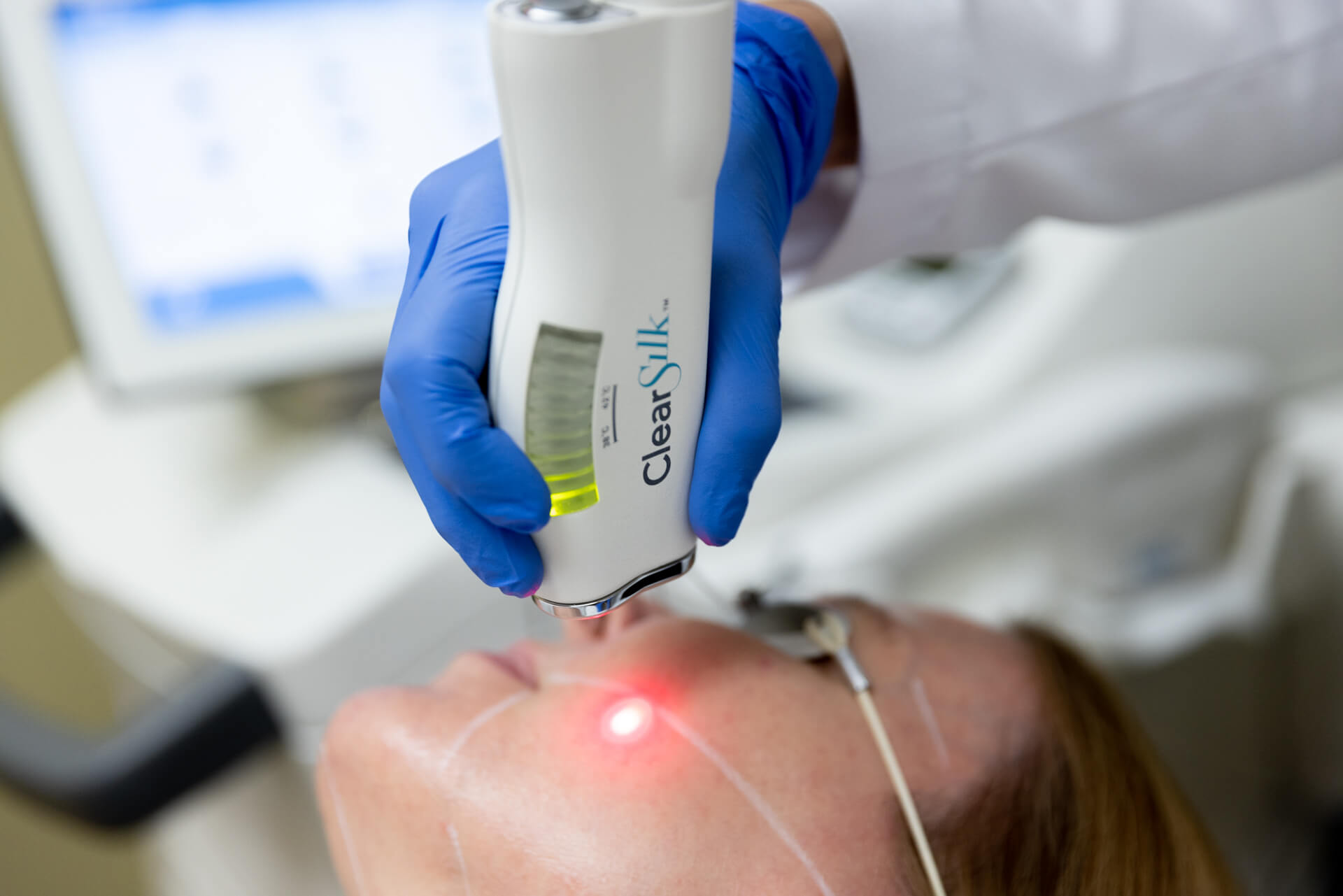white medical instrument being used on face