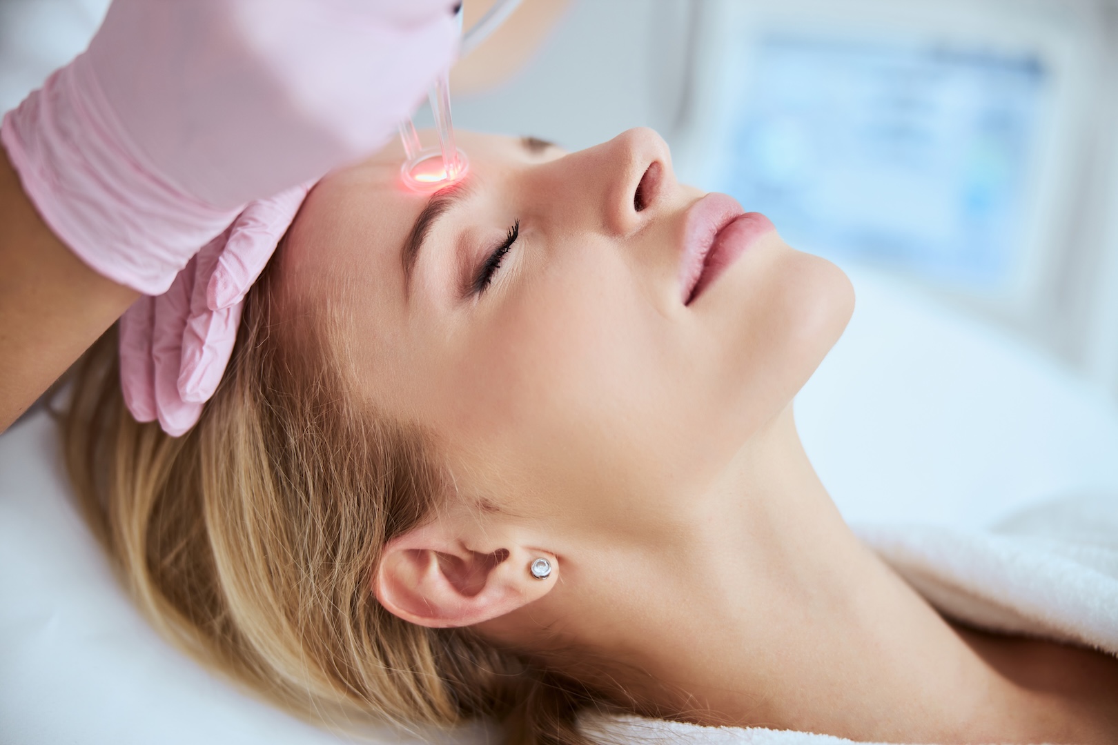 woman with eyes closed and lasers