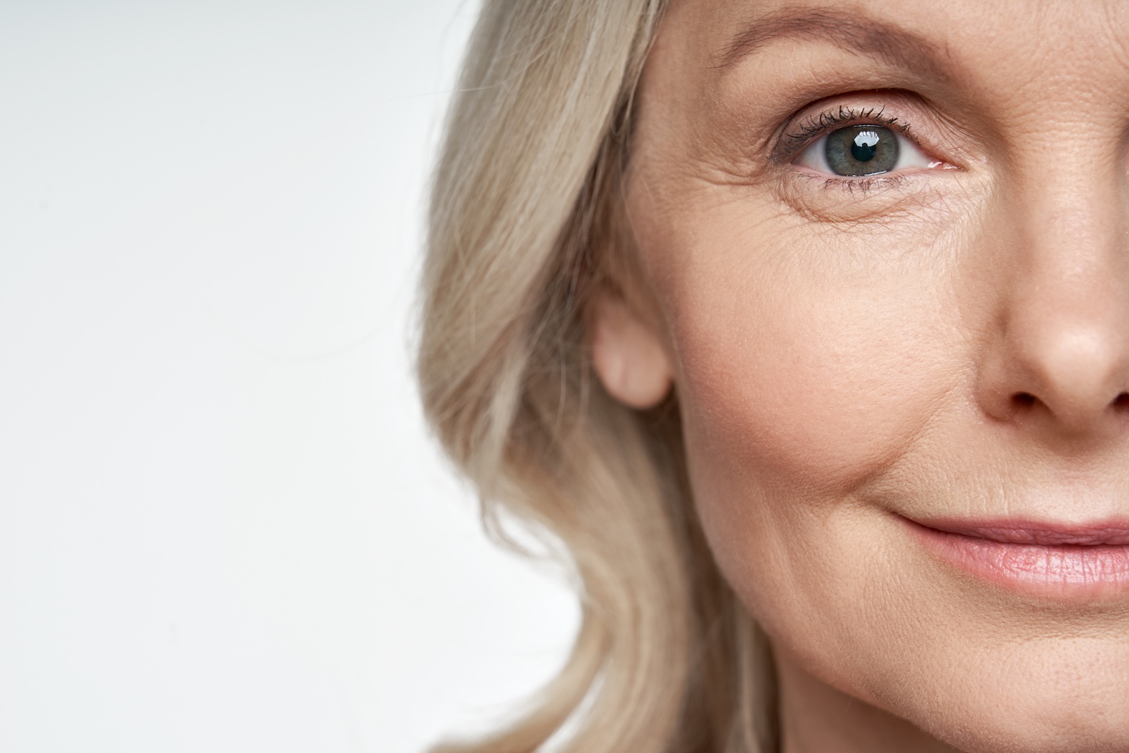 half of a woman's face smiling