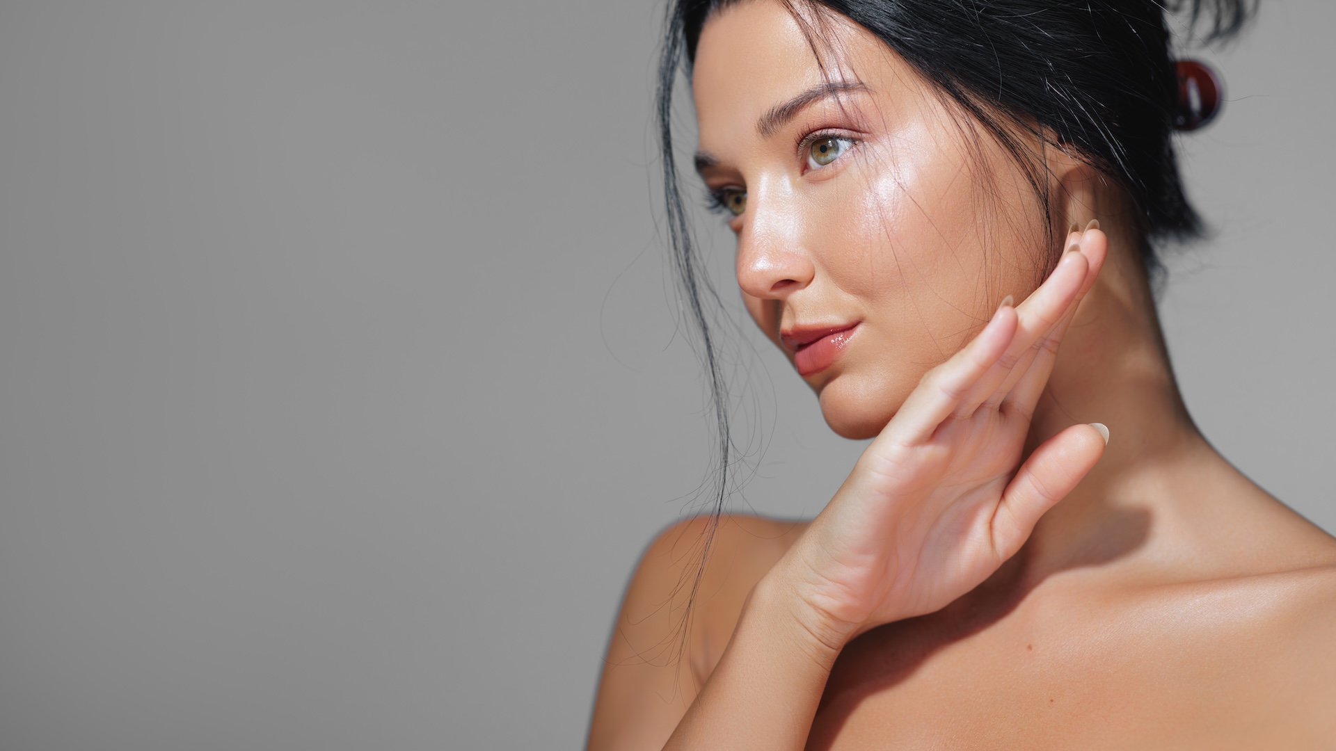 profile of woman touching her face