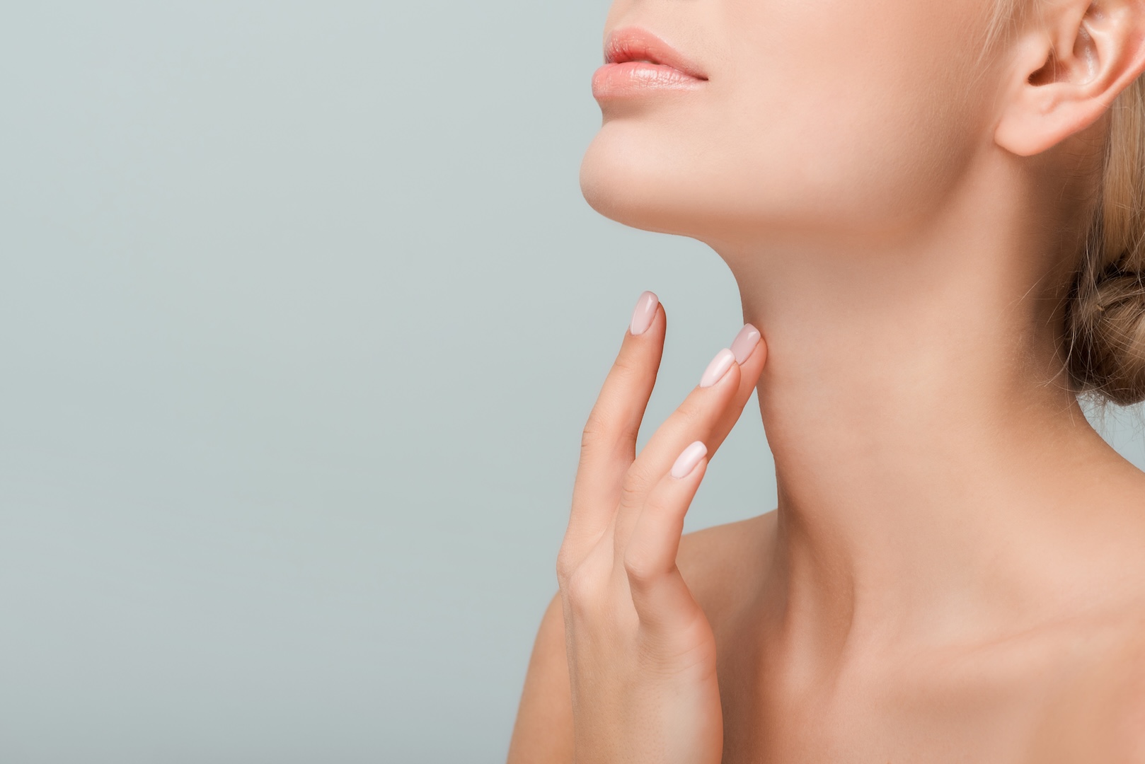 woman touching neck