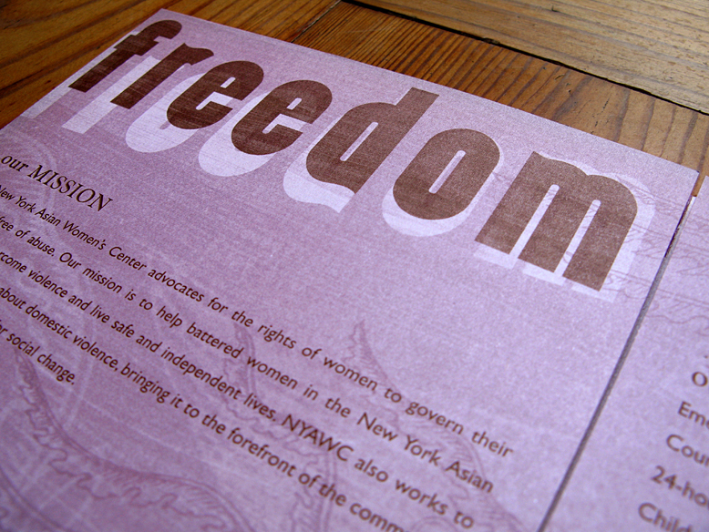 Interior spread of a brochure focusing on the word "freedom" set in decorative font on a purple duotone background