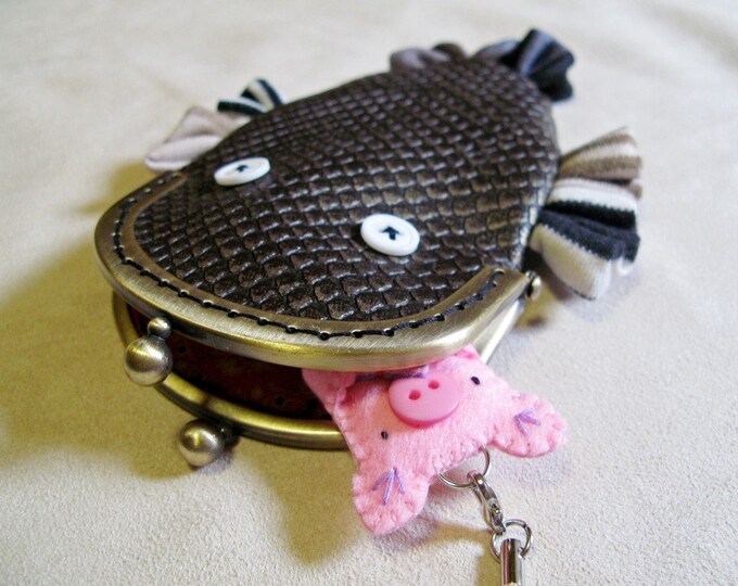 Pencil case in the shape of a purple axylotl.