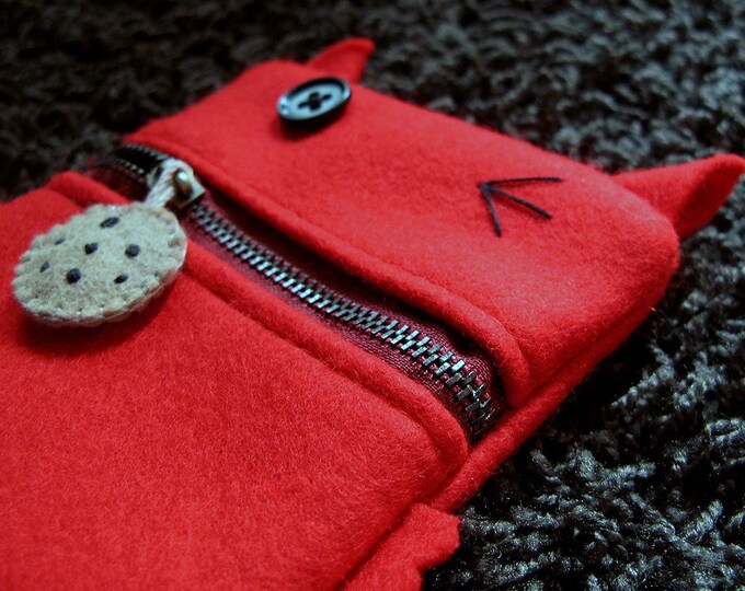 Pouch in the shape of a red felt devil, with a zipper mouth and a single button eye