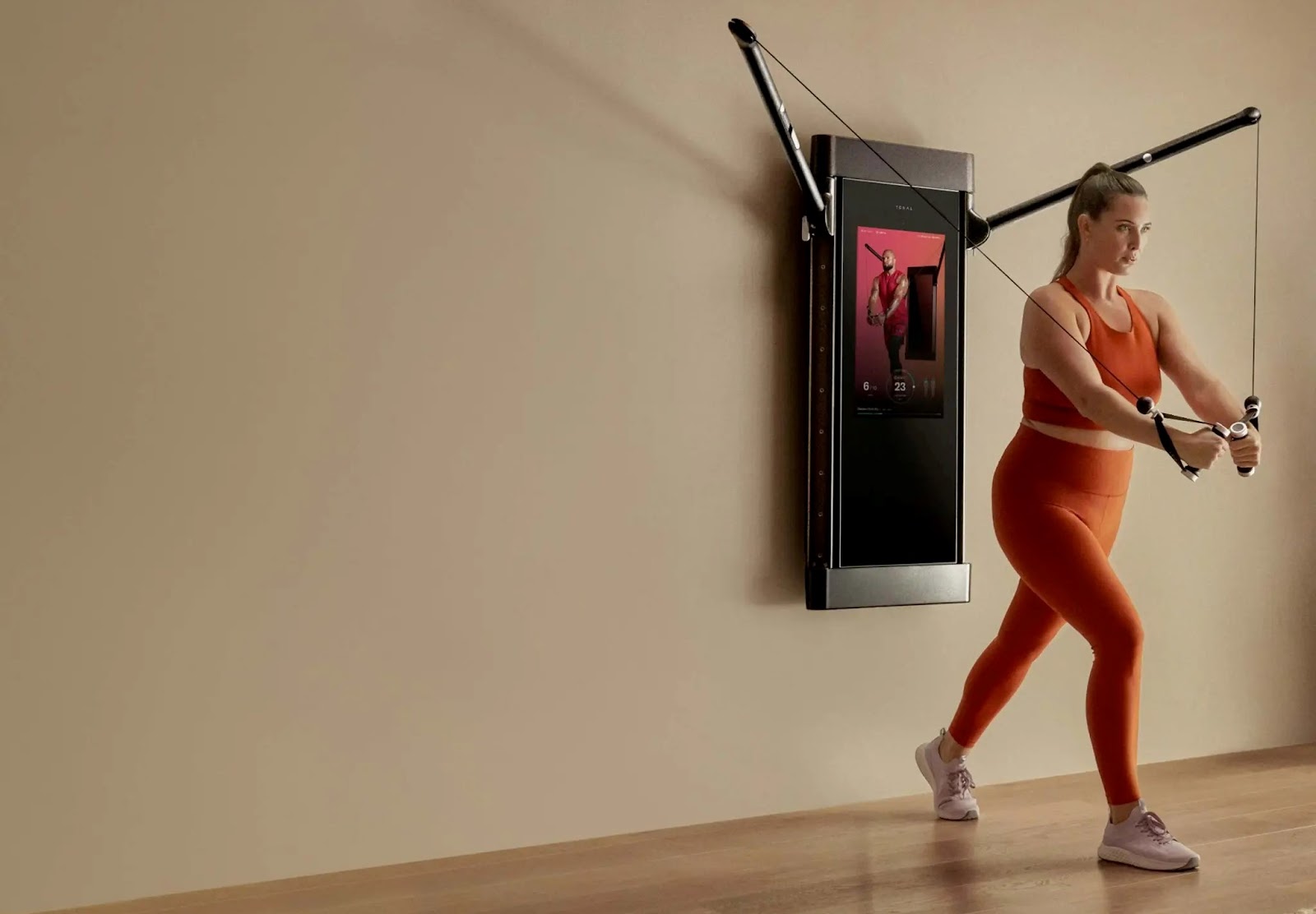 A woman using a connected fitness exercise device that uses Android
