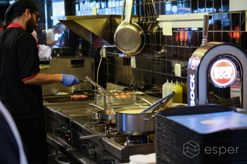 A chef working in the back of house of a restaurant