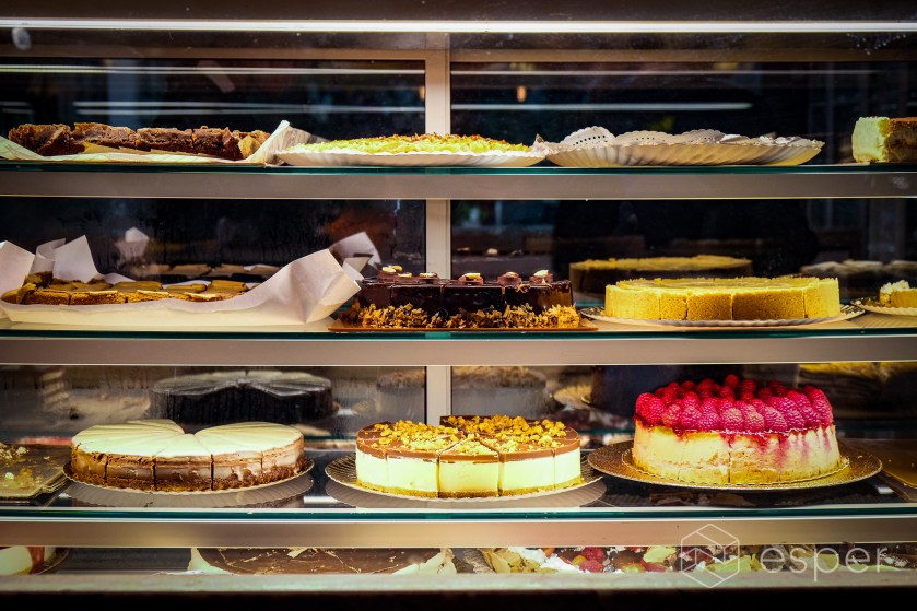 Glass window featuring cakes and pastries in a restaurant