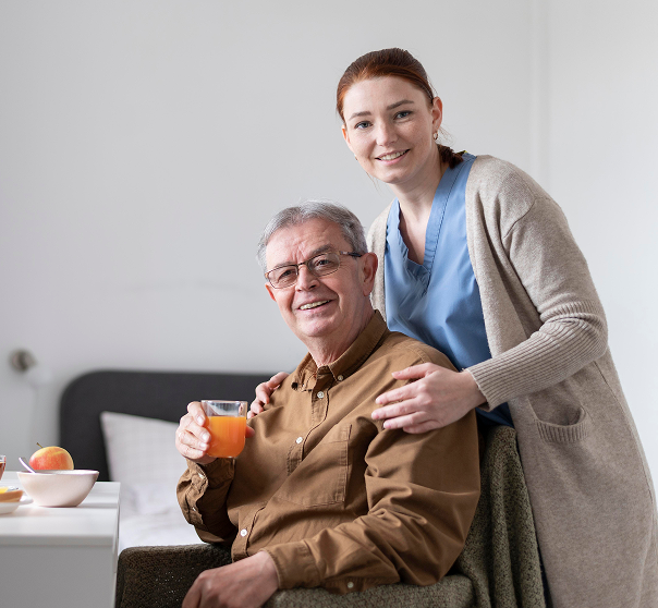 A health care specialist assisting an elderly man.