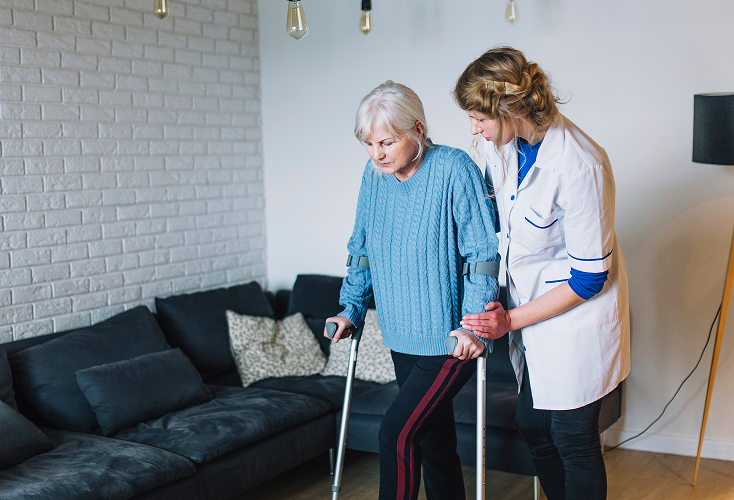 A home health care specialist assisting the elderly in daily activities.