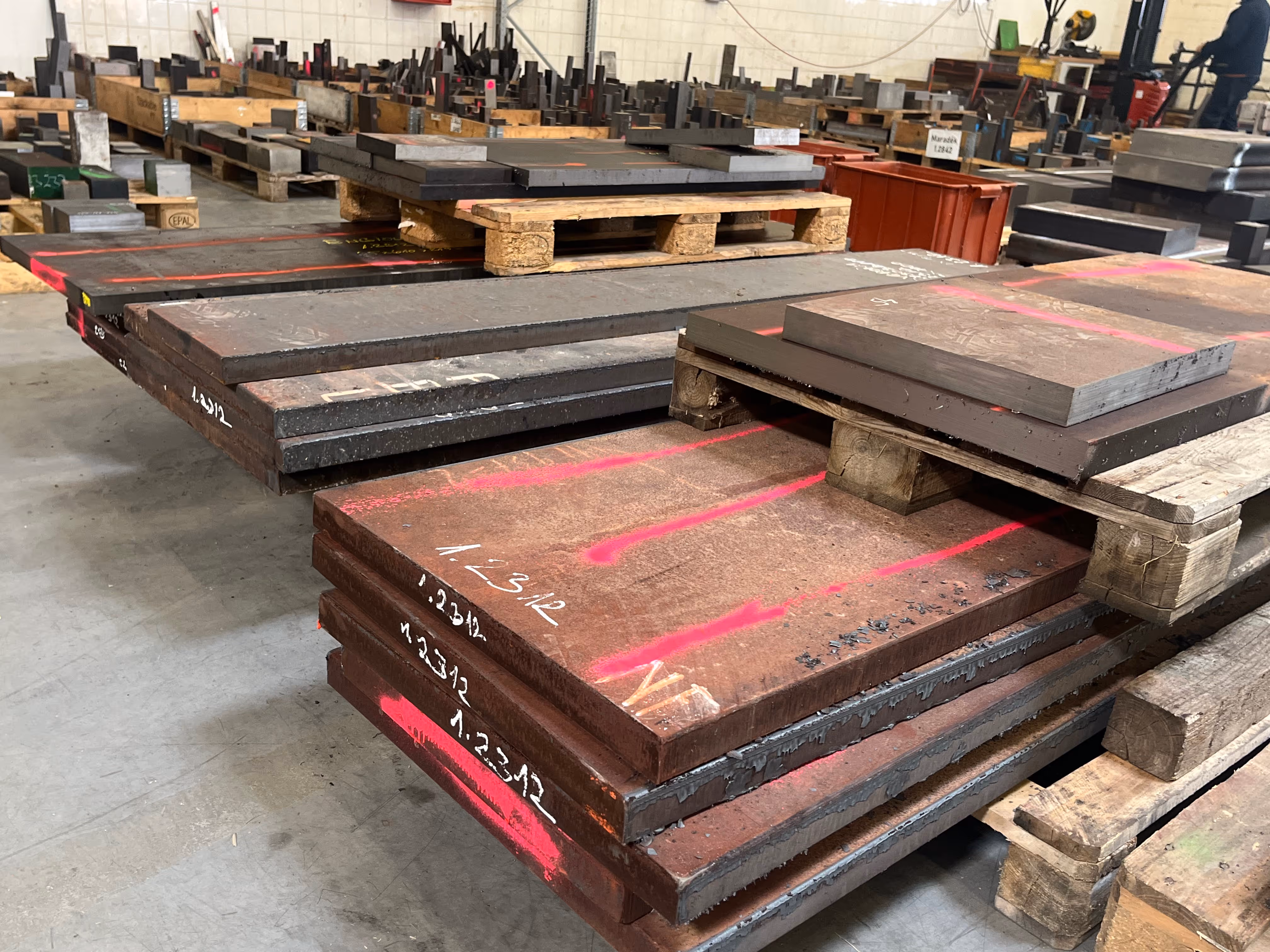 Multiple sheets of tool steel on racks