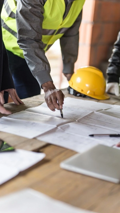 architect and engineer holding drawing