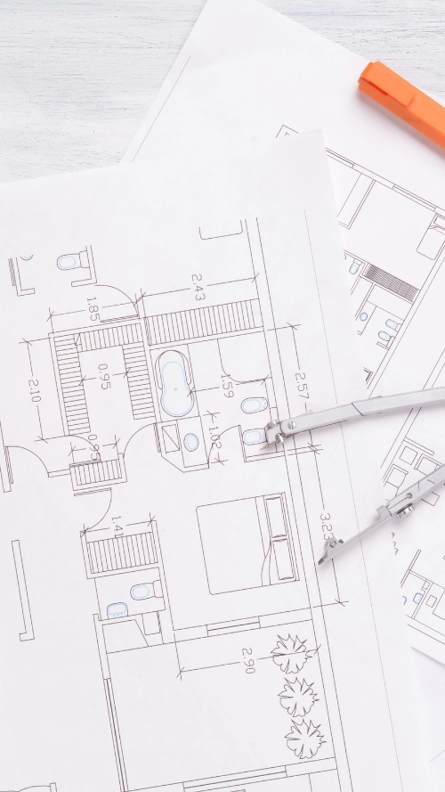 Person pointing at a 3D architectural model of a multi-story building displayed on a computer screen.