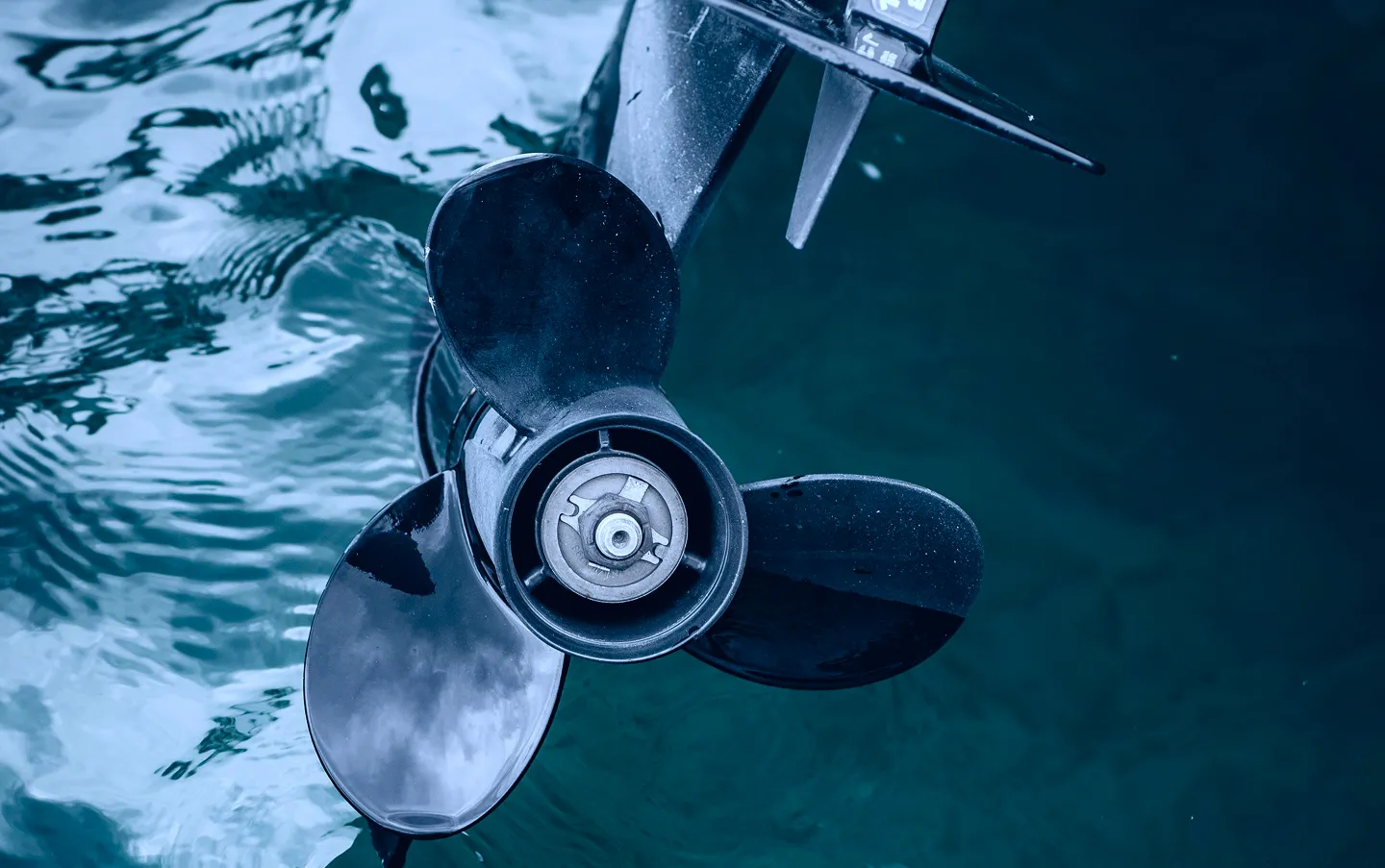 The propeller of a boat in the water.