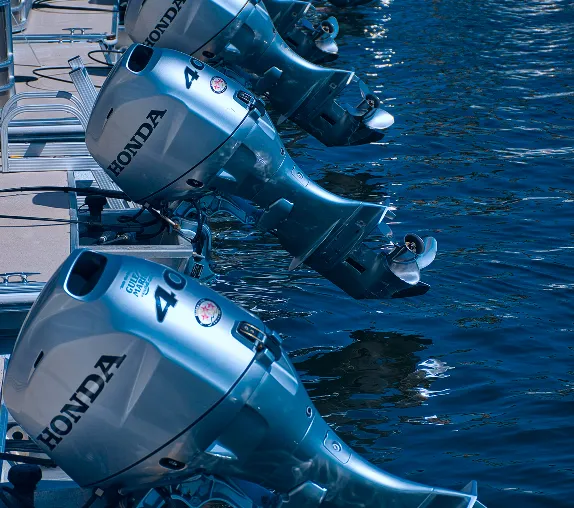 A row of motor boats sitting next to each other.