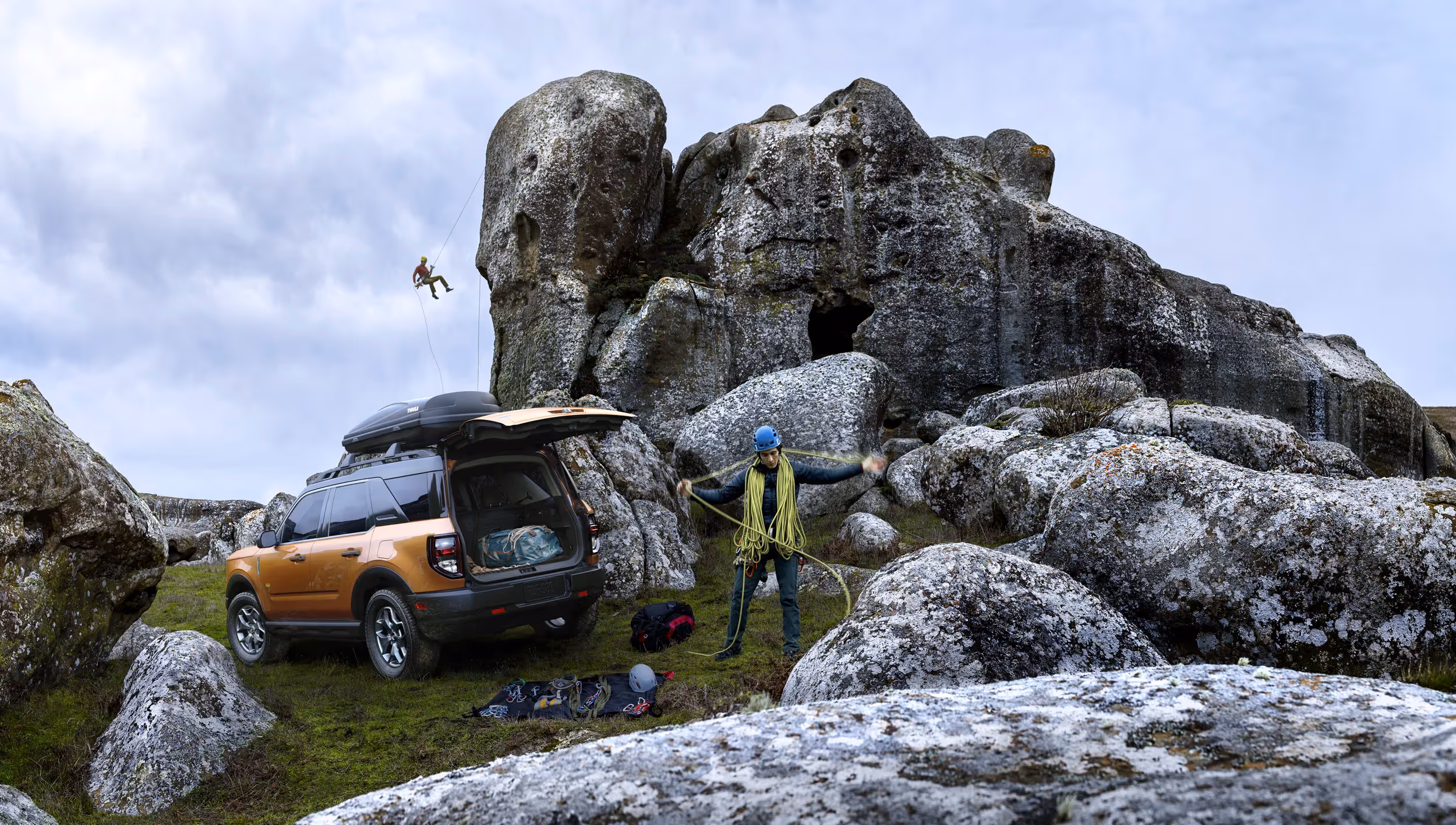 Ford Bronco Sport parked beside boulders as climbers prepare gear, rock climbing and adventure travel photography by Roe Photo.